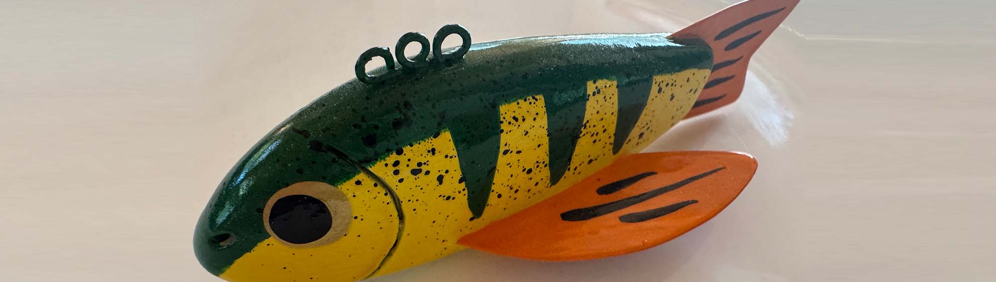 Ice fisherman using the Darkhouse Dipper to remove slush from a fishing hole